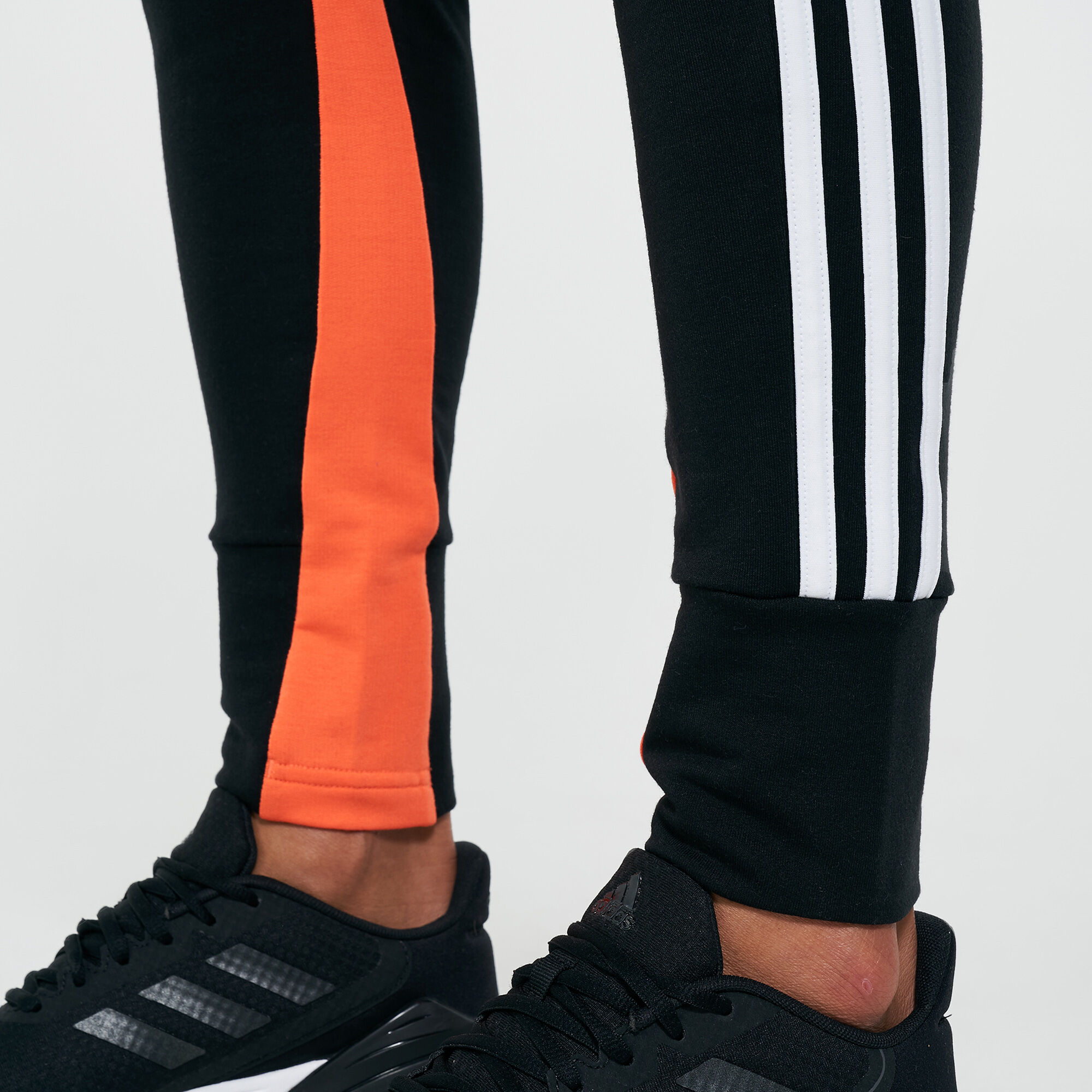 Black and orange clearance adidas track pants