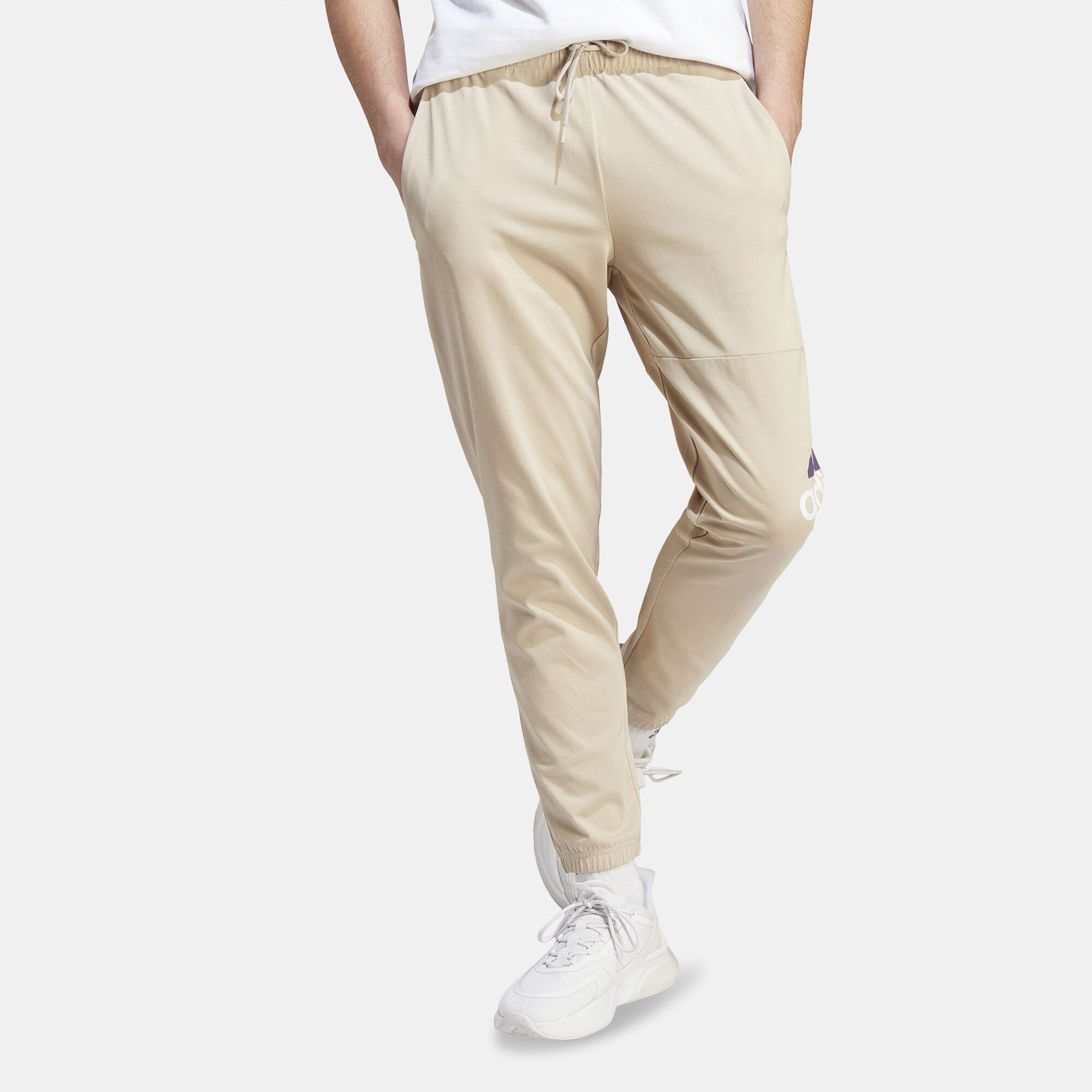 Buy adidas Men s Essentials Badge of Sport Tapered Joggers Beige