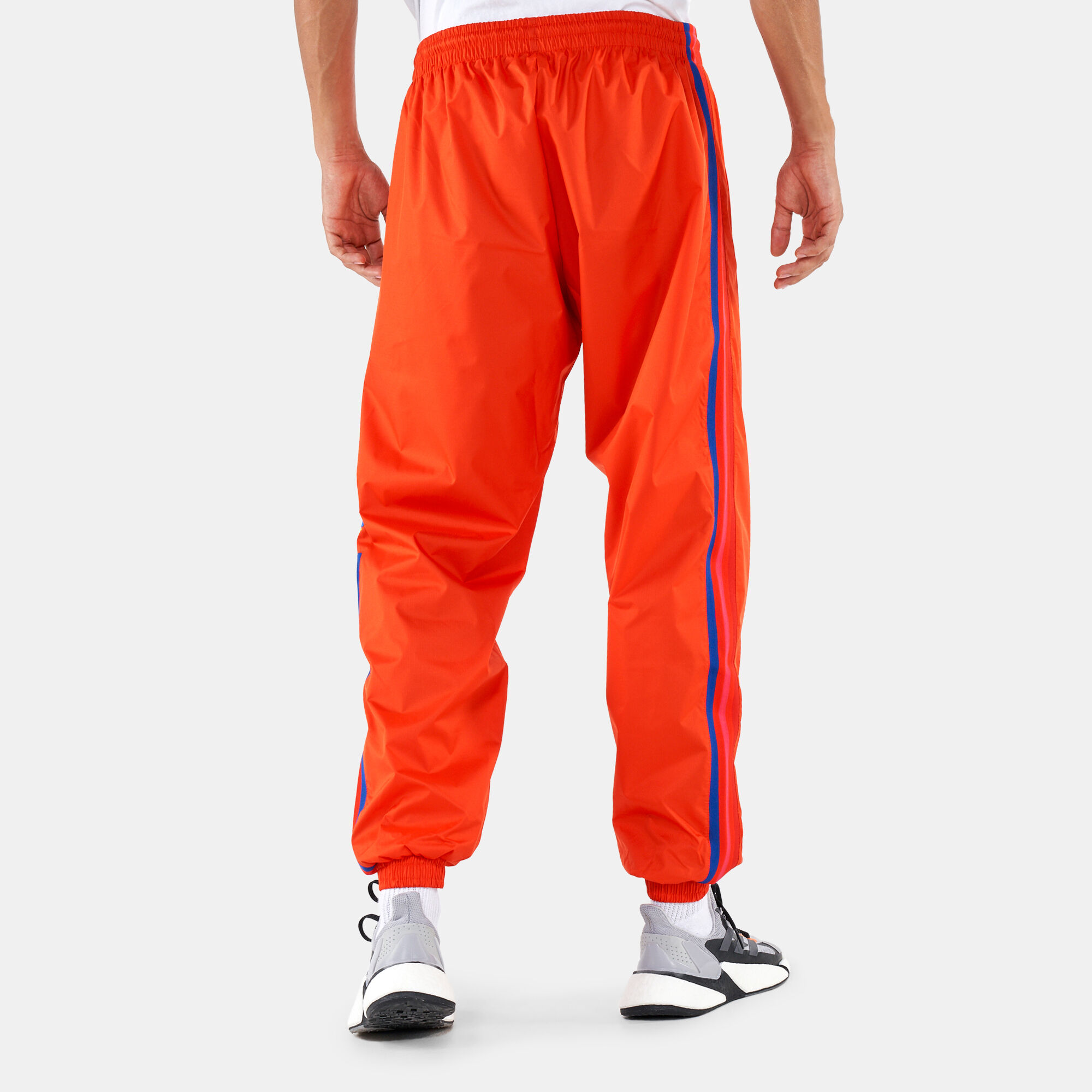 Adidas track pants orange stripe sales