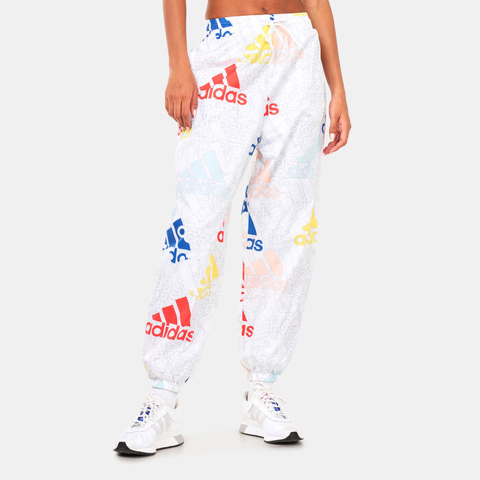adidas Women's Essentials Multi-Coloured Logo Loose Fit Woven Pants White adidas Women's Essentials Multi-Coloured Logo Loose Fit Woven Pants White image number 0